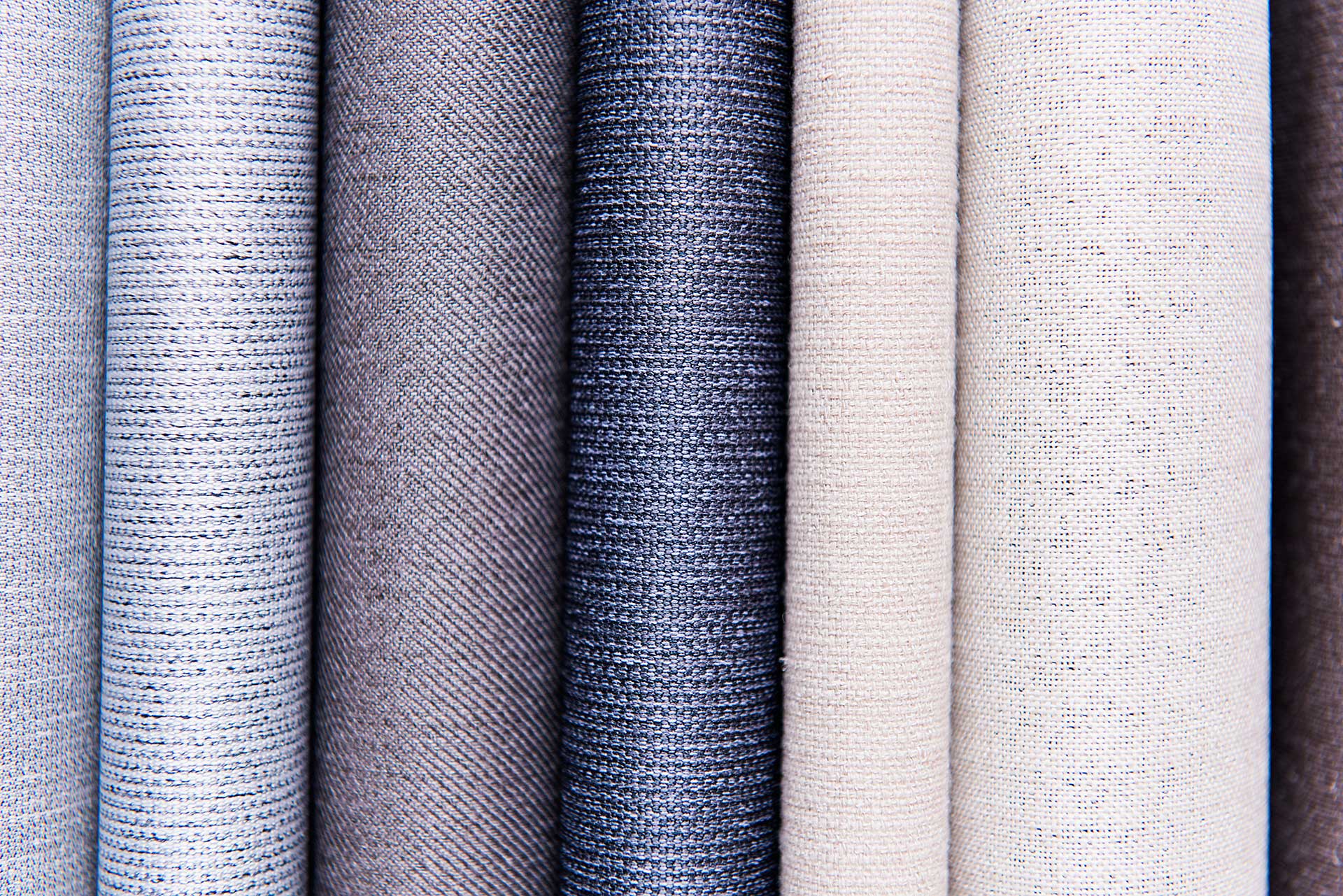 Rolls of high-quality curtain fabrics on display